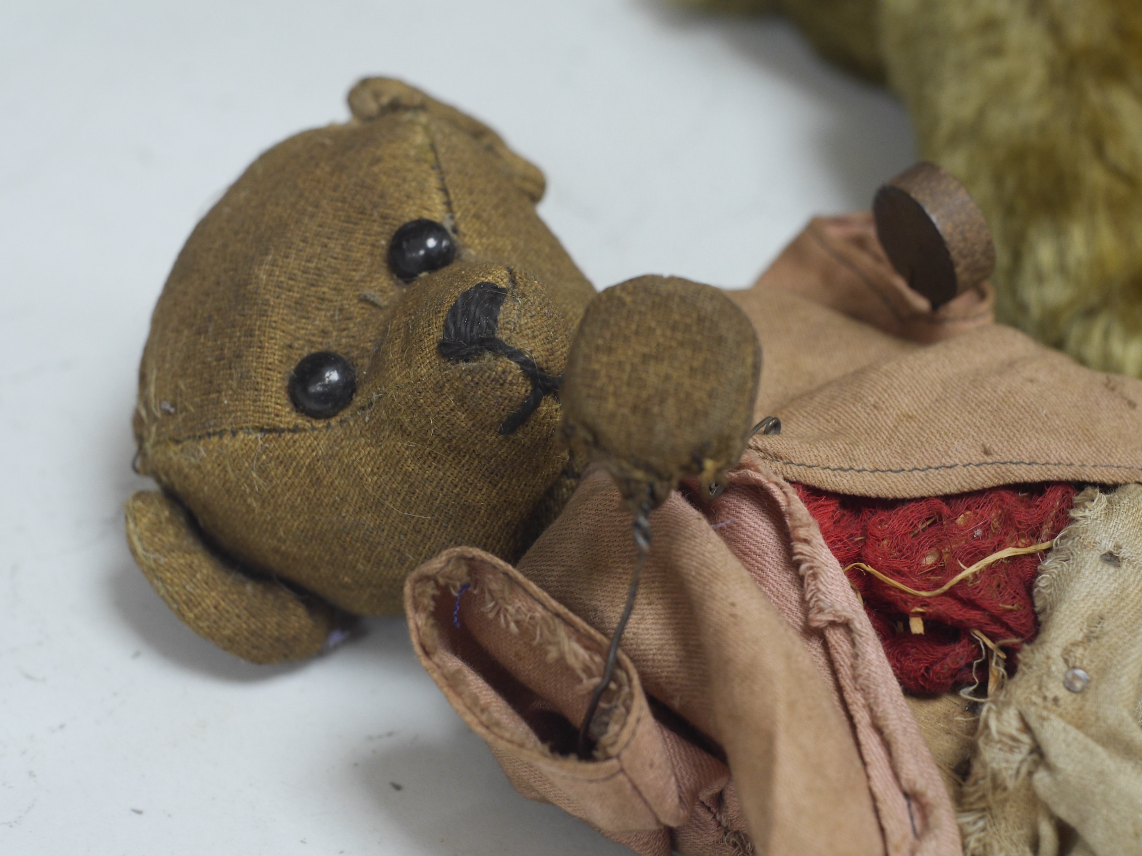 An early 20th century German hump backed plush teddy bear and three others, German teddy 30cm high. Condition - the German teddy has a short split on the back seam and glue on the front leg that needs removing and plush